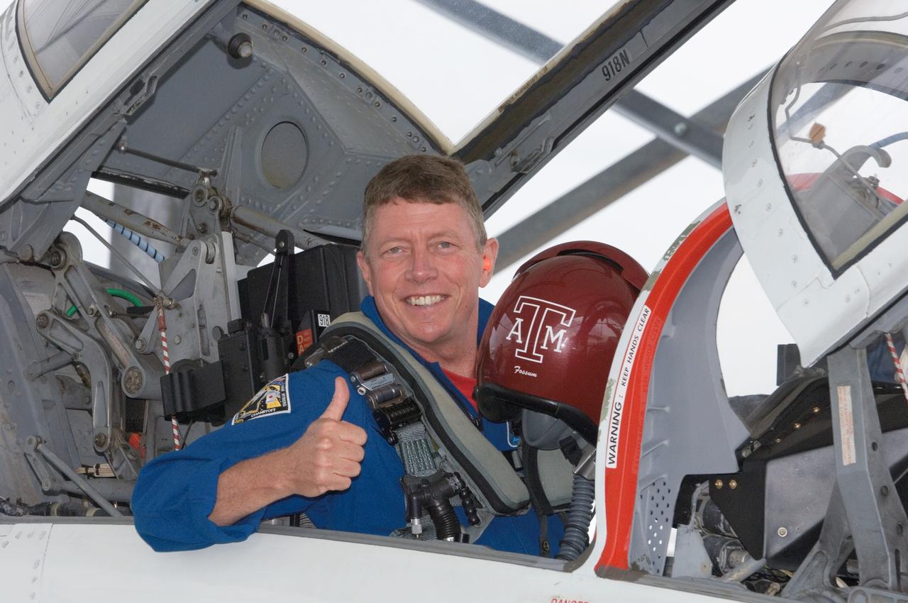 JSC2008-E-038930 (6 May 2008) --- Astronaut Mike Fossum, STS-124 mission specialist, photographed in the rear station of a NASA T-38 trainer jet, gives a "thumbs-up" signal as he prepares for a flight from Ellington Field near NASA's Johnson Space Center to Kennedy Space Center, Florida.