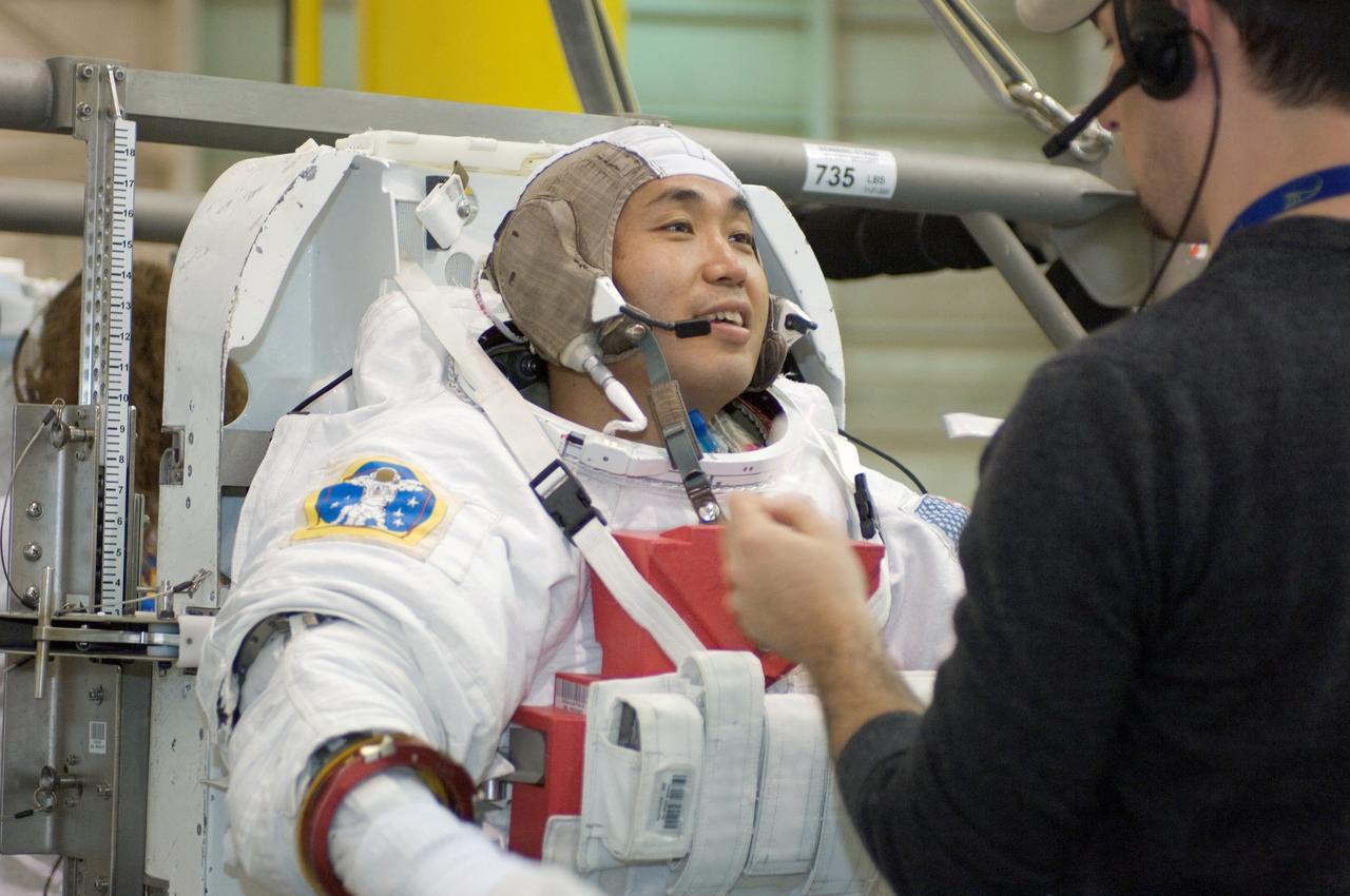 JSC2008-E-039240 (12 May 2008) --- Japan Aerospace Exploration Agency (JAXA) astronaut Koichi Wakata, Expedition 18 flight engineer, gets help donning a training version of the Extravehicular Mobility Unit (EMU) spacesuit prior to being submerged in the waters of the Neutral Buoyancy Laboratory (NBL) near NASA's Johnson Space Center.