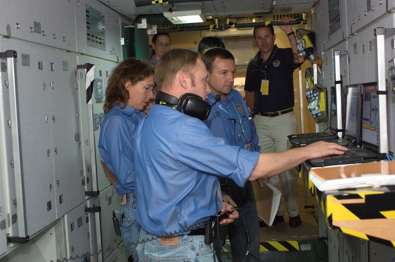 JSC2008-E-040994 (21 May 2008) --- Expedition 18 crewmembers participate in a space station emergency scenarios training session in the Space Vehicle Mockup Facility at NASA's Johnson Space Center. Pictured are NASA astronauts Edward M. (Mike) Fincke (foreground), commander; Sandra H. Magnus, Russian Federal Space Agency cosmonaut Yuri V. Lonchakov and Japan Aerospace Exploration Agency (JAXA) astronaut Koichi Wakata (partially obscured), all flight engineers.