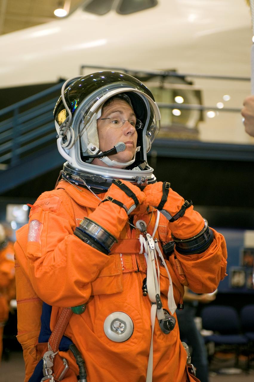JSC2008-E-044987 (3 June 2008) --- Astronaut Sandra H. Magnus, Expedition 18 flight engineer, dons a training version of her shuttle launch and entry suit in preparation for a Full Fuselage Trainer (FFT) mockup (out of frame) training session in the Space Vehicle Mockup Facility at NASA's Johnson Space Center.