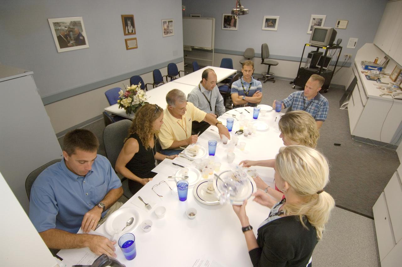 JSC2008-E-047936 (19 June 2008) --- STS-127 crewmembers participate in a food tasting session in the Flight Projects Division Laboratory at NASA's Johnson Space Center. Seated from the left are NASA astronaut Christopher J. Cassidy, Canadian Space Agency astronaut Julie Payette, NASA astronauts David A. Wolf, all mission specialists; Mark L. Polansky, commander; Thomas H. Marshburn, mission specialist; and Douglas G. Hurley, pilot. Dieticians (right foreground) assisted the crewmembers.