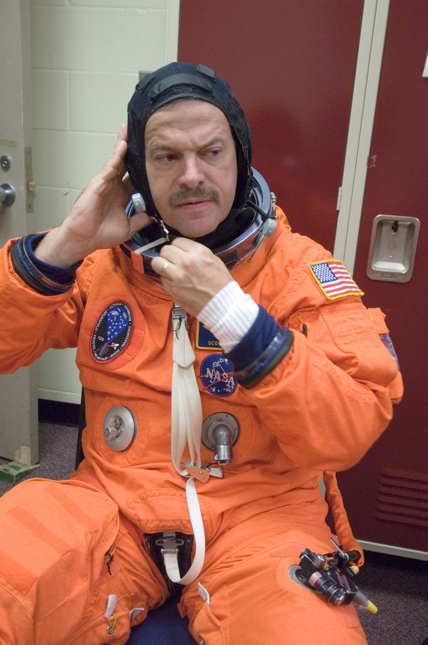 JSC2008-E-047947 (4 June 2008) --- Astronaut Scott D. Altman, STS-125 commander, dons a training version of his shuttle launch and entry suit in preparation for a training session in the Space Vehicle Mockup Facility at NASA's Johnson Space Center.