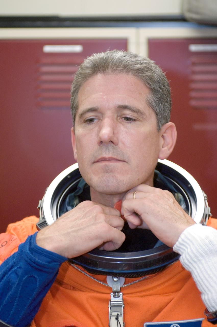 JSC2008-E-047951 (4 June 2008) --- Astronaut Michael T. Good, STS-125 mission specialist, dons a training version of his shuttle launch and entry suit in preparation for a training session in the Space Vehicle Mockup Facility at NASA's Johnson Space Center.
