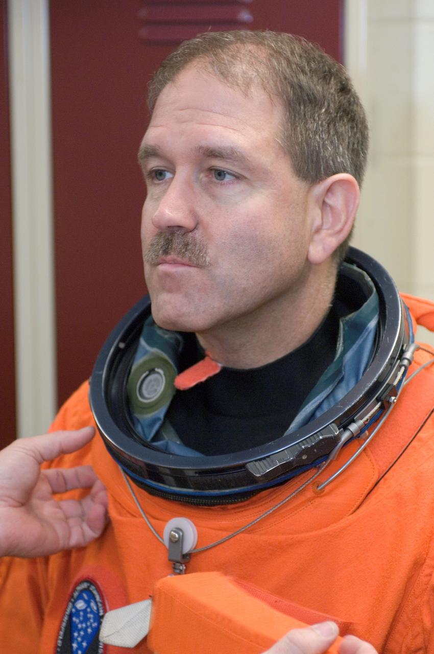 JSC2008-E-047958 (4 June 2008) --- Astronaut John M. Grunsfeld, STS-125 mission specialist, dons a training version of his shuttle launch and entry suit in preparation for a training session in the Space Vehicle Mockup Facility at NASA's Johnson Space Center.