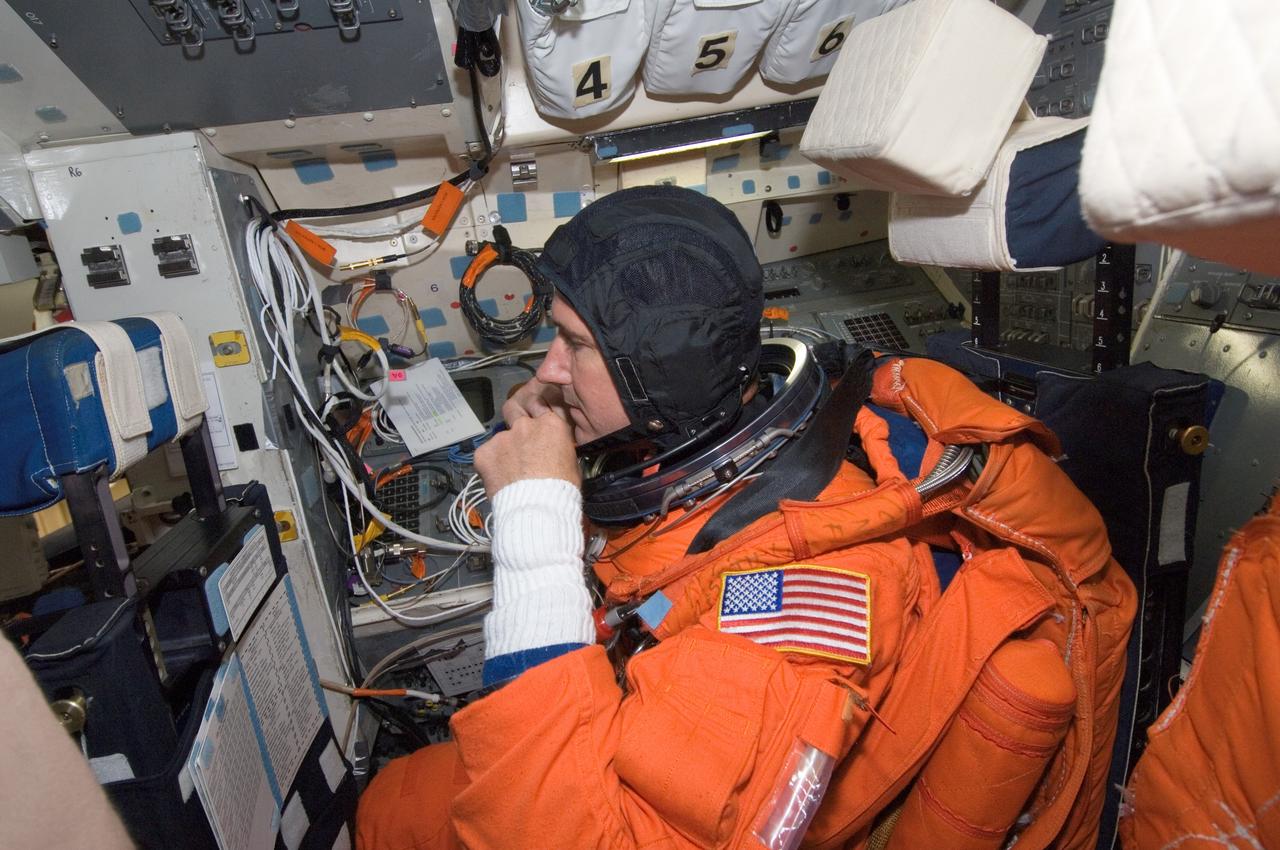 JSC2008-E-047968 (4 June 2008) --- While seated on the flight deck, astronaut Michael T. Good, STS-125 mission specialist, participates in a training session in one of the full-scale trainers in the Space Vehicle Mockup Facility at NASA's Johnson Space Center. Good is attired in a training version of his shuttle launch and entry suit.