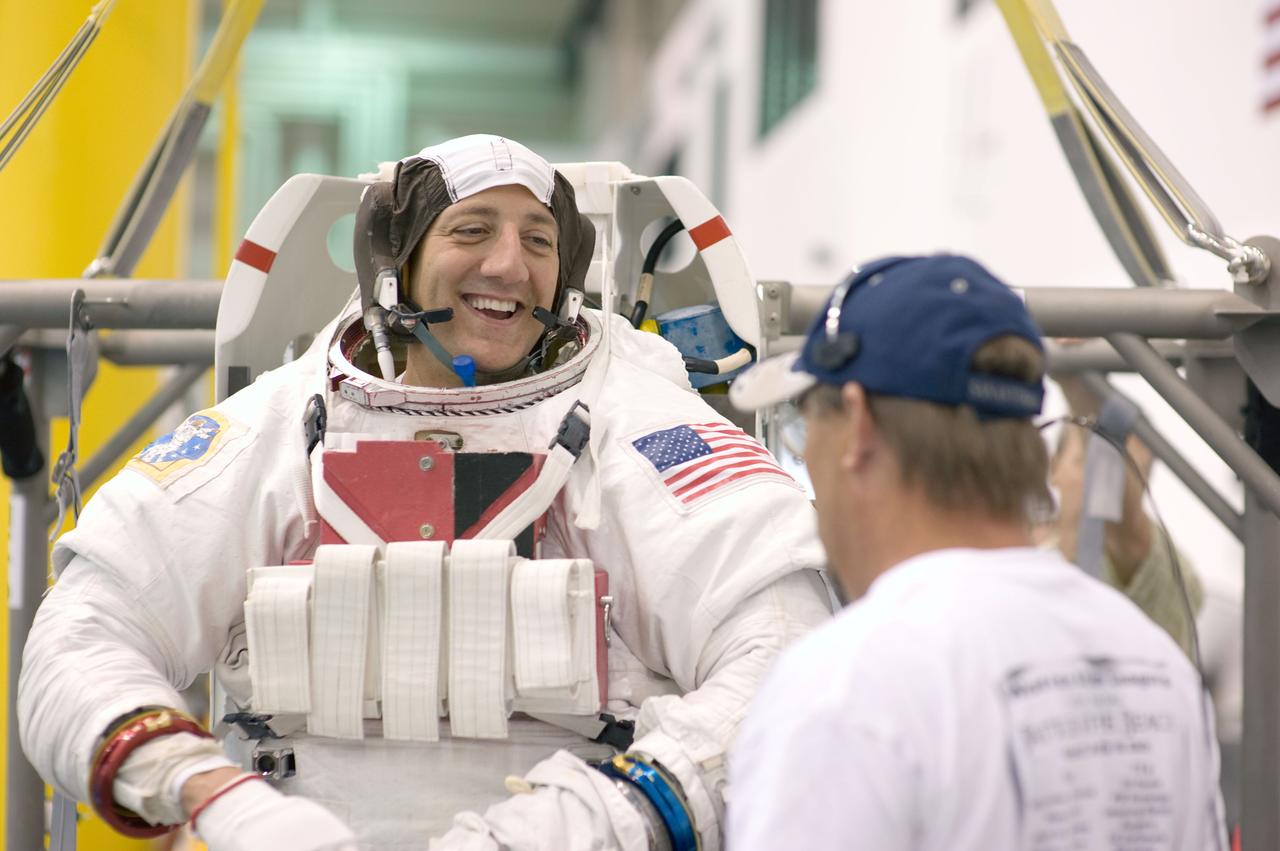 JSC2008-E-118365 (25 Sept. 2008) --- Attired in a training version of his Extravehicular Mobility Unit (EMU) spacesuit, astronaut Mike Massimino, STS-125 mission specialist, awaits the start of a training session in the waters of the Neutral Buoyancy Laboratory (NBL) near NASA's Johnson Space Center.