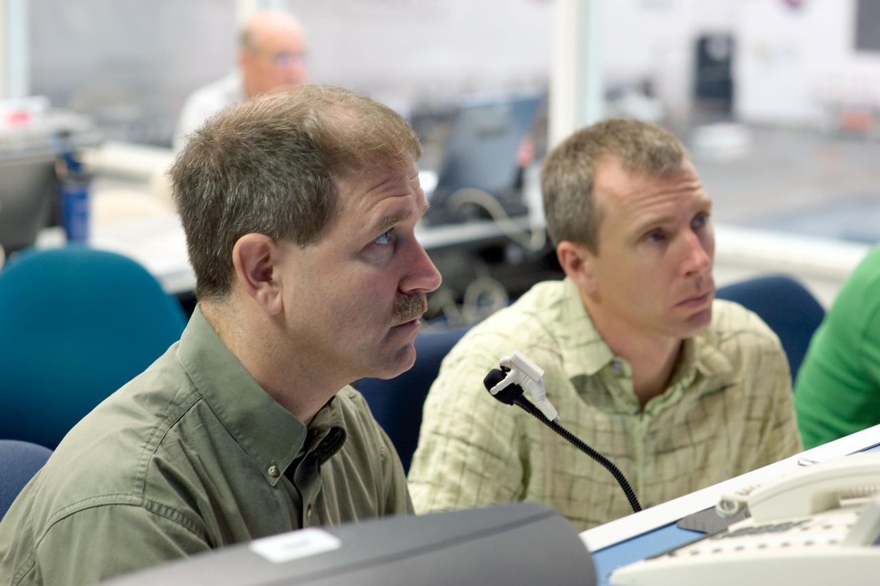 JSC2008-E-118383 (25 Sept. 2008) --- Astronauts John Grunsfeld (left) and Andrew Feustel, both STS-125 mission specialists, participate in a training session at consoles in the simulation control area in the Neutral Buoyancy Laboratory (NBL) at the Sonny Carter Training Facility near NASA's Johnson Space Center.