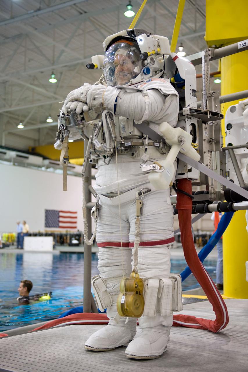 JSC2008-E-118429 (26 Sept. 2008) --- Astronaut John Grunsfeld, STS-125 mission specialist, attired in a training version of his Extravehicular Mobility Unit (EMU) spacesuit, awaits the start of a training session in the waters of the Neutral Buoyancy Laboratory (NBL) near NASA's Johnson Space Center.