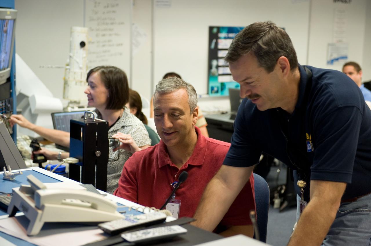 JSC2008-E-118445 (26 Sept. 2008) --- Astronauts Scott Altman (right), STS-125 commander; Mike Massimino and Megan McArthur, both mission specialists, participate in a training session in the simulation control area in the Neutral Buoyancy Laboratory (NBL) at the Sonny Carter Training Facility near NASA's Johnson Space Center.