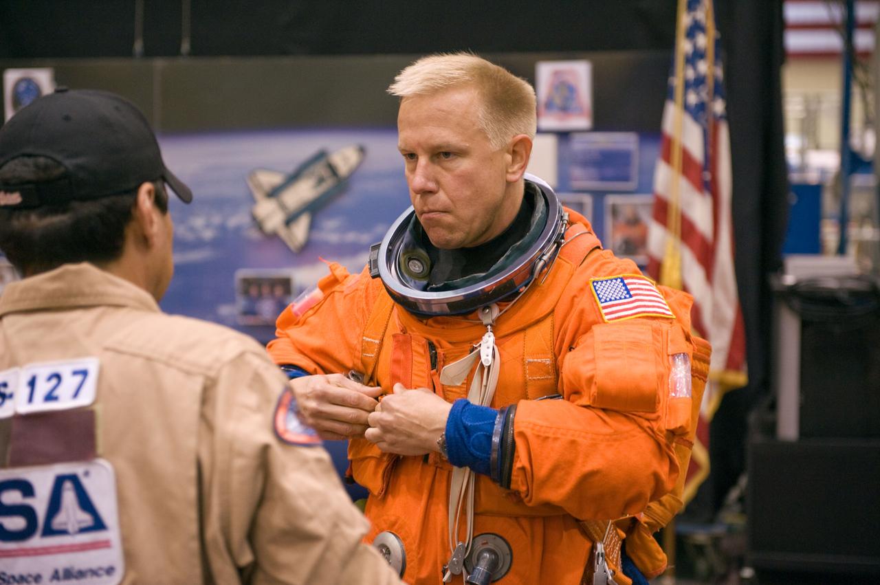 JSC2008-E-122420 (7 Oct. 2008) --- Astronaut Tim Kopra, STS-127 mission specialist, dons a training version of his shuttle launch and entry suit in preparation for a training session in the Space Vehicle Mock-up Facility at NASA's Johnson Space Center. Kopra is scheduled to join Expedition 19 as flight engineer after launching to the International Space Station with the STS-127 crew.