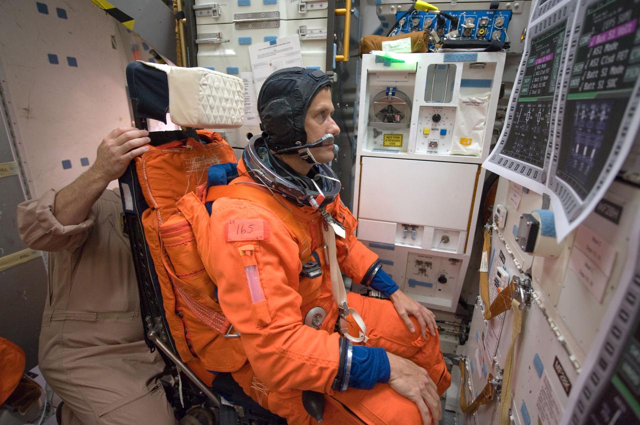 JSC2008-E-122437 (7 Oct. 2008) --- Astronaut Tom Marshburn, STS-127 mission specialist, participates in a training session in one of the full-scale trainers in the Space Vehicle Mockup Facility at NASA's Johnson Space Center. Attired in a training version of his shuttle launch and entry suit, Marshburn is seated on the middeck for a post insertion/de-orbit training session.