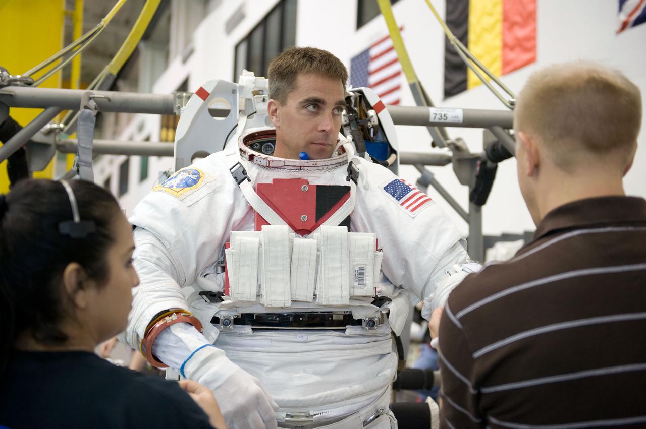 JSC2008-E-124034 (20 Oct. 2008) --- Astronaut Christopher Cassidy, STS-127 mission specialist, gets help with the donning of a training version of his Extravehicular Mobility Unit (EMU) spacesuit in preparation for a training session in the waters of the Neutral Buoyancy Laboratory (NBL) near NASA's Johnson Space Center.