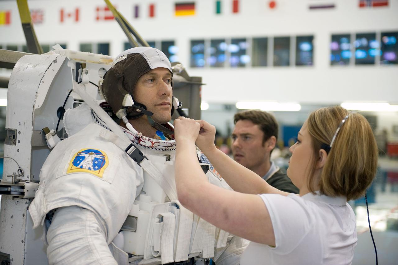 JSC2008-E-124037 (20 Oct. 2008) --- Astronaut Tom Marshburn, STS-127 mission specialist, gets help with the donning of a training version of his Extravehicular Mobility Unit (EMU) spacesuit in preparation for a training session in the waters of the Neutral Buoyancy Laboratory (NBL) near NASA's Johnson Space Center.