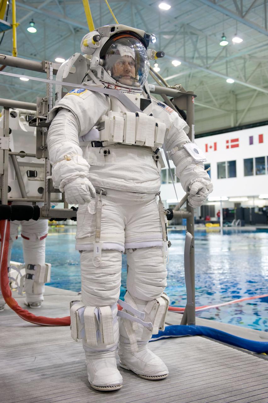 JSC2008-E-124047 (20 Oct. 2008) --- Astronaut Tom Marshburn, STS-127 mission specialist, attired in a training version of his Extravehicular Mobility Unit (EMU) spacesuit, awaits the start of a training session in the waters of the Neutral Buoyancy Laboratory (NBL) near NASA's Johnson Space Center.