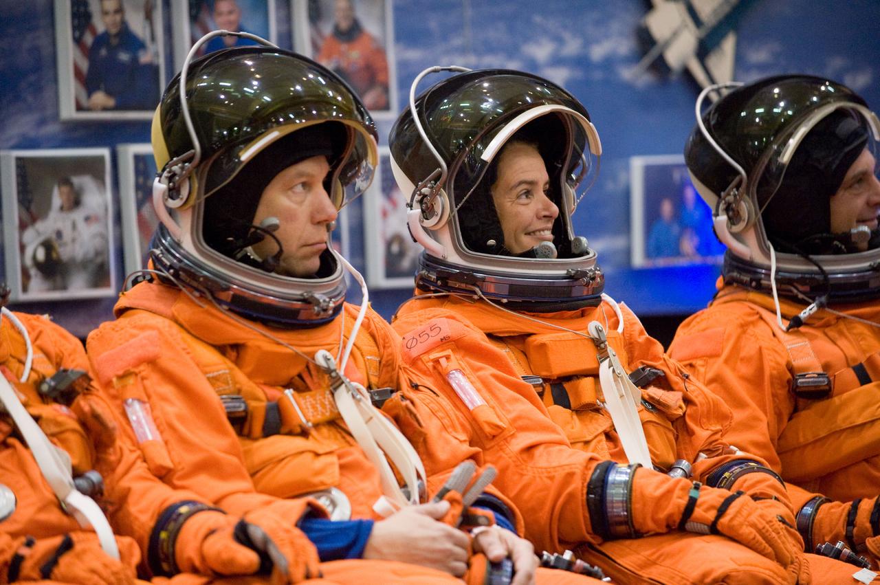 JSC2008-E-139816 (12 Nov. 2008) --- Astronaut Tim Kopra (left), Canadian Space Agency astronaut Julie Payette, and astronaut Dave Wolf, all STS-127 mission specialists, attired in training versions of their shuttle launch and entry suits, await the start of a training session in the Space Vehicle Mock-up Facility at NASA's Johnson Space Center. Kopra is scheduled to join Expedition 19 as flight engineer after launching to the International Space Station with the STS-127 crew.