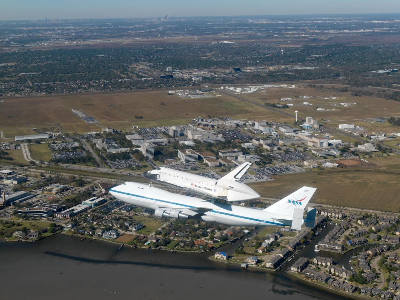 The Space Shuttle Endeavour, on the back of a Boeing 747, circles over Johnson Space Center (JSC) on its way back to Kennedy Space Center (KSC).