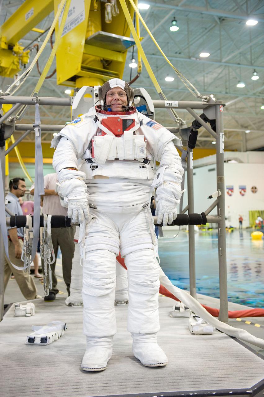JSC2009-E-061377 (23 March 2009) --- European Space Agency (ESA) astronaut Christer Fuglesang, STS-128 mission specialist, attired in a training version of his Extravehicular Mobility Unit (EMU) spacesuit, is about to be submerged in the waters of the Neutral Buoyancy Laboratory (NBL) near NASA's Johnson Space Center. Divers (out of frame) are in the water to assist Fuglesang in his rehearsal, intended to help prepare him for work on the exterior of the International Space Station.