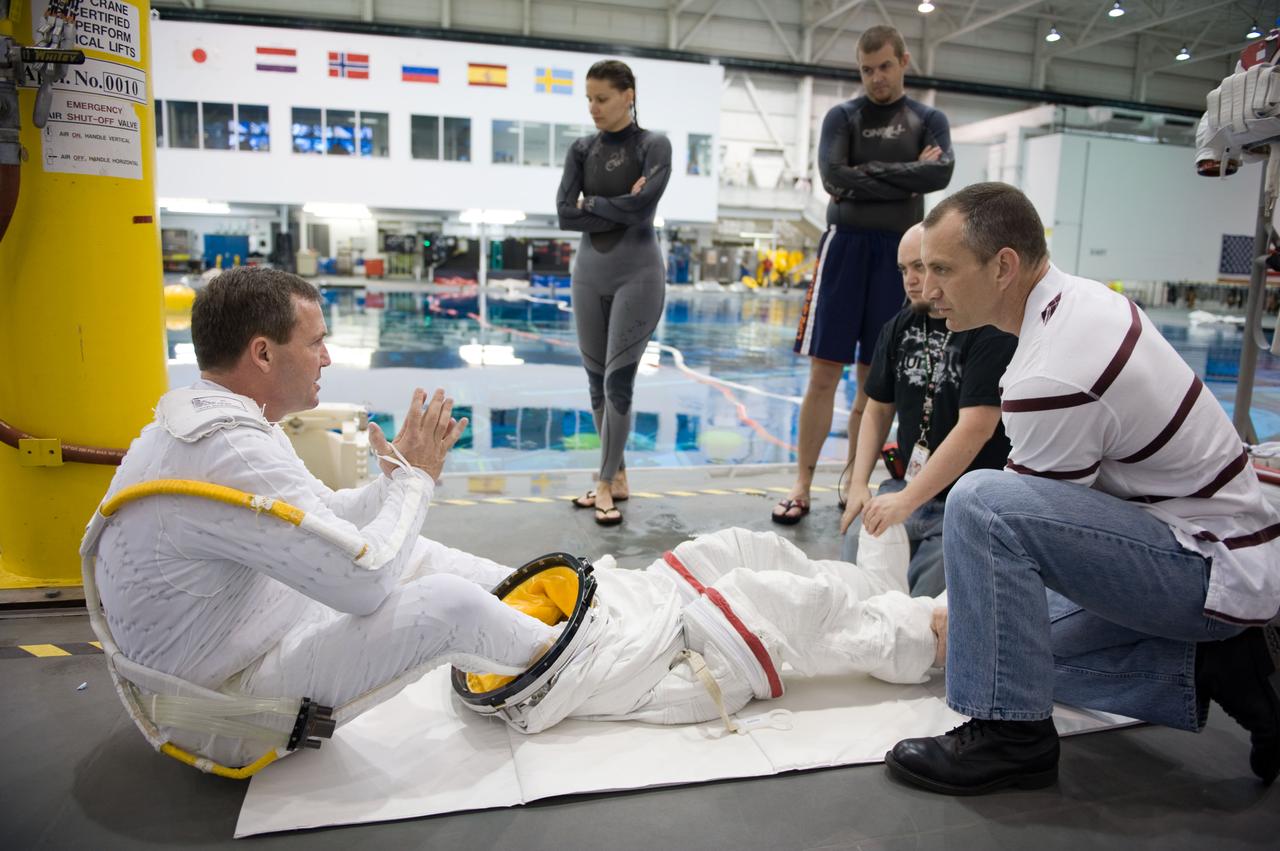 STS-129 crew members Mike Foreman, Randy Bresnik, Barry 'Butch' Wilmore and Robert Satcher prepare for 20A EVA Review dive at the NBL. Photo Date: March 26, 2009. Location - NBL Pool Topside and Control Room.  Photographer: Robert Markowitz