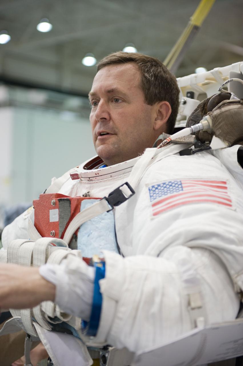 STS-129 crew members Mike Foreman, Randy Bresnik, Barry 'Butch' Wilmore and Robert Satcher prepare for 20A EVA Review dive at the NBL. Photo Date: March 26, 2009. Location - NBL Pool Topside and Control Room.  Photographer: Robert Markowitz