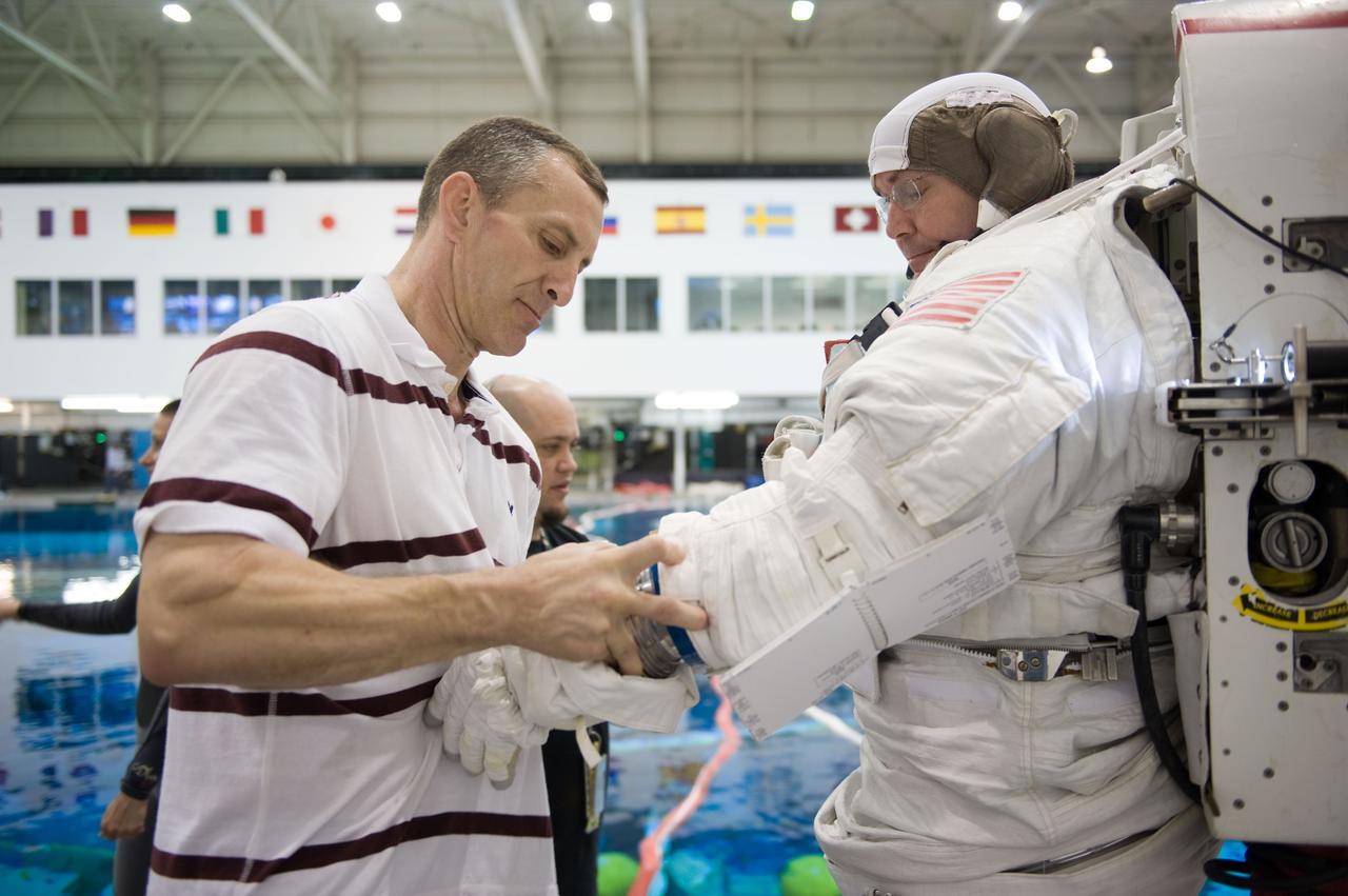 STS-129 crew members Mike Foreman, Randy Bresnik, Barry 'Butch' Wilmore and Robert Satcher prepare for 20A EVA Review dive at the NBL. Photo Date: March 26, 2009. Location - NBL Pool Topside and Control Room.  Photographer: Robert Markowitz