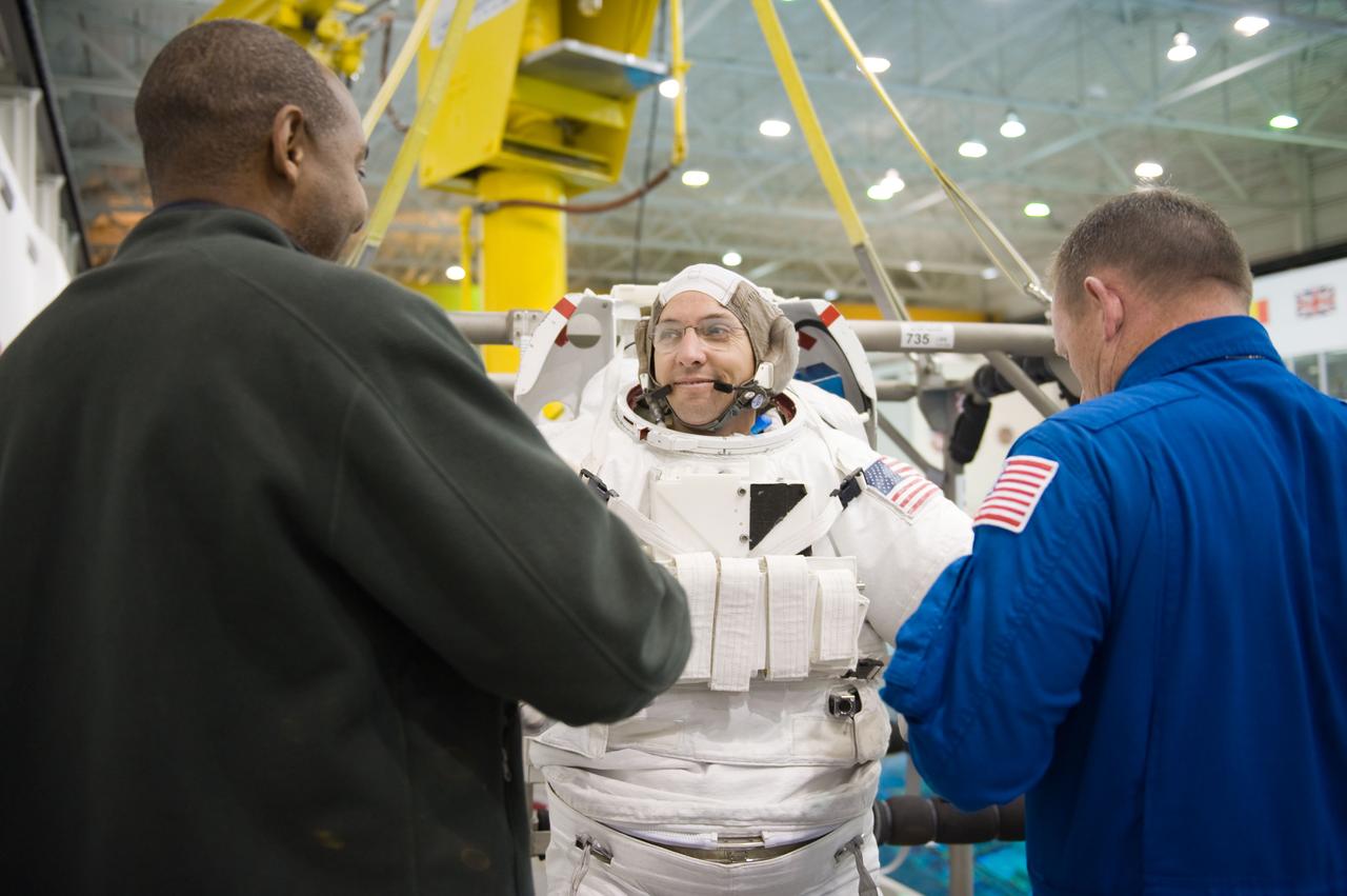 STS-129 crew members Mike Foreman, Randy Bresnik, Barry 'Butch' Wilmore and Robert Satcher prepare for 20A EVA Review dive at the NBL. Photo Date: March 26, 2009. Location - NBL Pool Topside and Control Room.  Photographer: Robert Markowitz