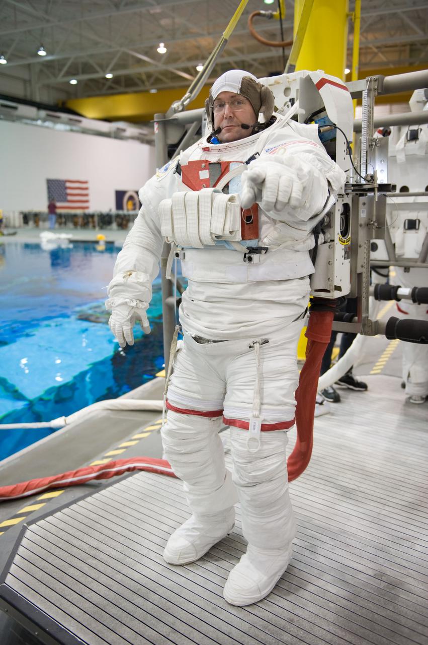STS-129 crew members Mike Foreman, Randy Bresnik, Barry 'Butch' Wilmore and Robert Satcher prepare for 20A EVA Review dive at the NBL. Photo Date: March 26, 2009. Location - NBL Pool Topside and Control Room.  Photographer: Robert Markowitz