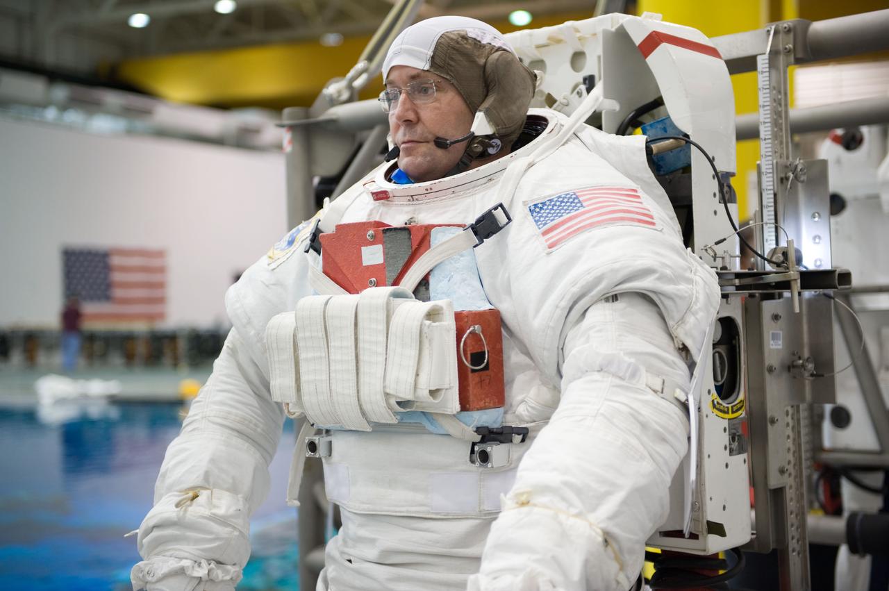 STS-129 crew members Mike Foreman, Randy Bresnik, Barry 'Butch' Wilmore and Robert Satcher prepare for 20A EVA Review dive at the NBL. Photo Date: March 26, 2009. Location - NBL Pool Topside and Control Room.  Photographer: Robert Markowitz