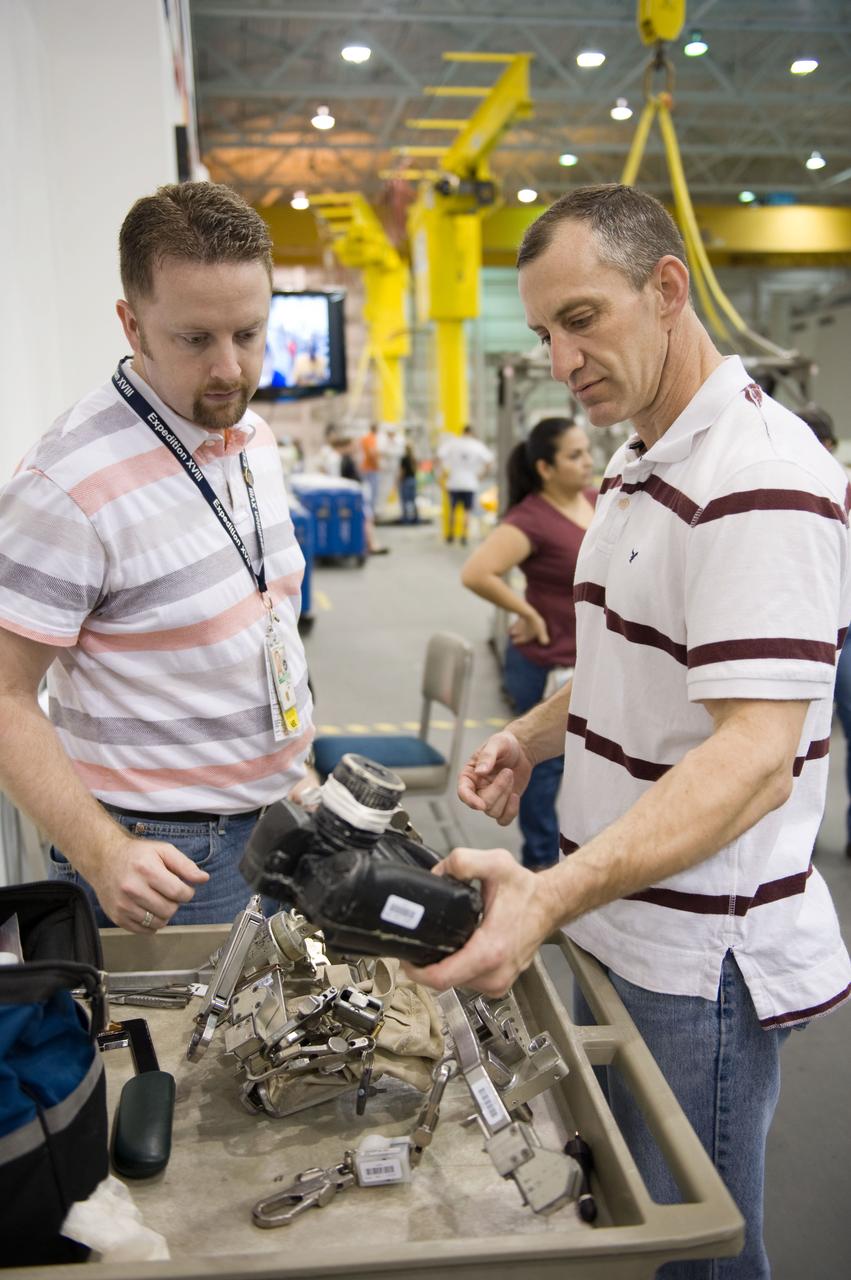 STS-129 crew members Mike Foreman, Randy Bresnik, Barry 'Butch' Wilmore and Robert Satcher prepare for 20A EVA Review dive at the NBL. Photo Date: March 26, 2009. Location - NBL Pool Topside and Control Room.  Photographer: Robert Markowitz
