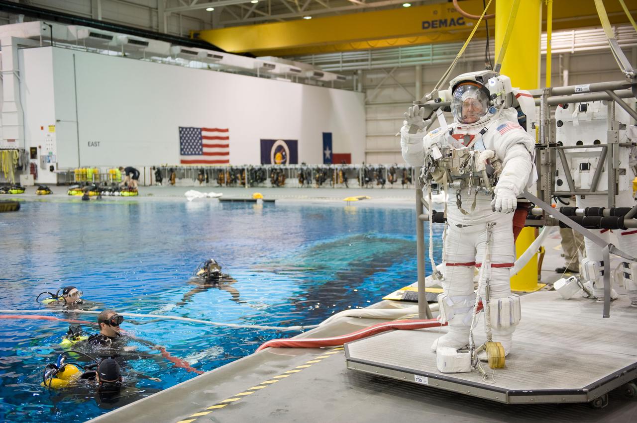 STS-129 crew members Mike Foreman, Randy Bresnik, Barry 'Butch' Wilmore and Robert Satcher prepare for 20A EVA Review dive at the NBL. Photo Date: March 26, 2009. Location - NBL Pool Topside and Control Room.  Photographer: Robert Markowitz