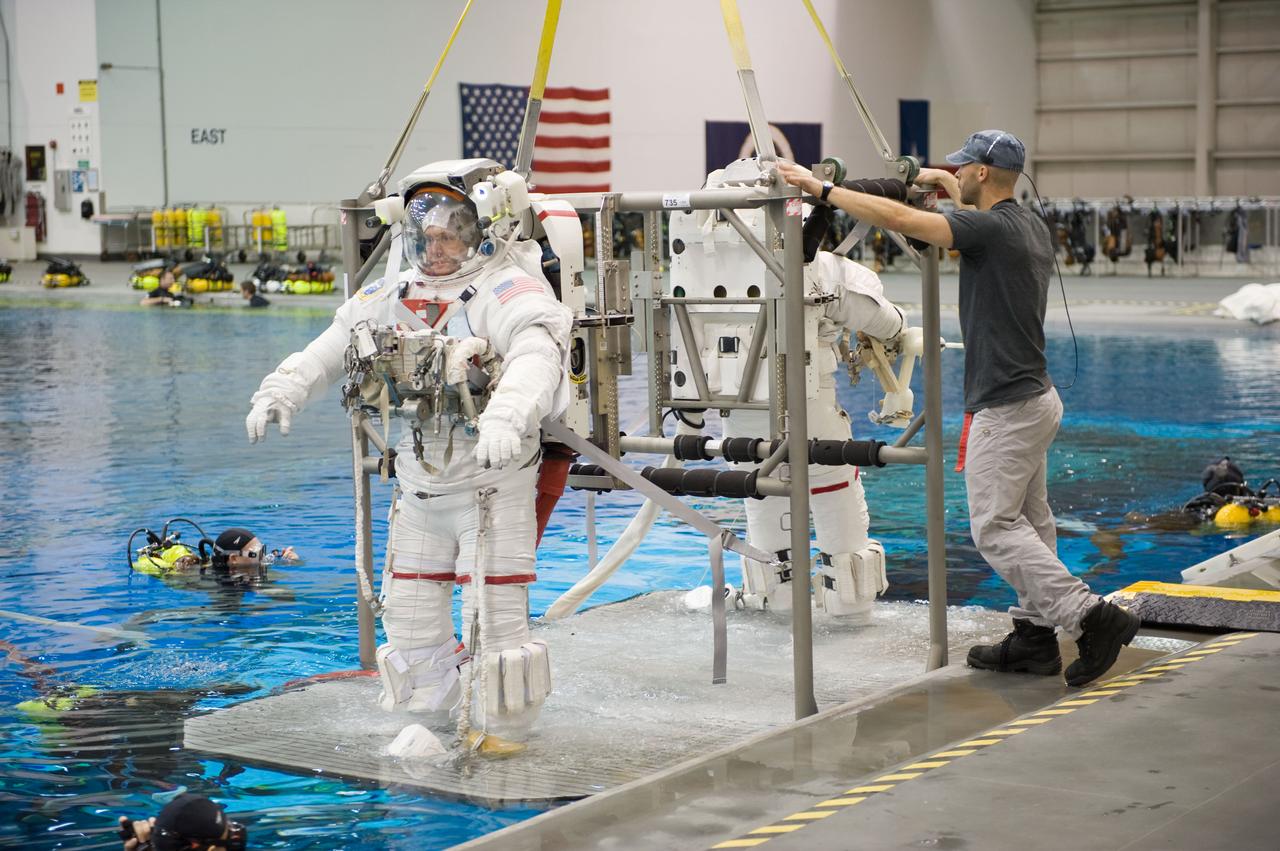 STS-129 crew members Mike Foreman, Randy Bresnik, Barry 'Butch' Wilmore and Robert Satcher prepare for 20A EVA Review dive at the NBL. Photo Date: March 26, 2009. Location - NBL Pool Topside and Control Room.  Photographer: Robert Markowitz