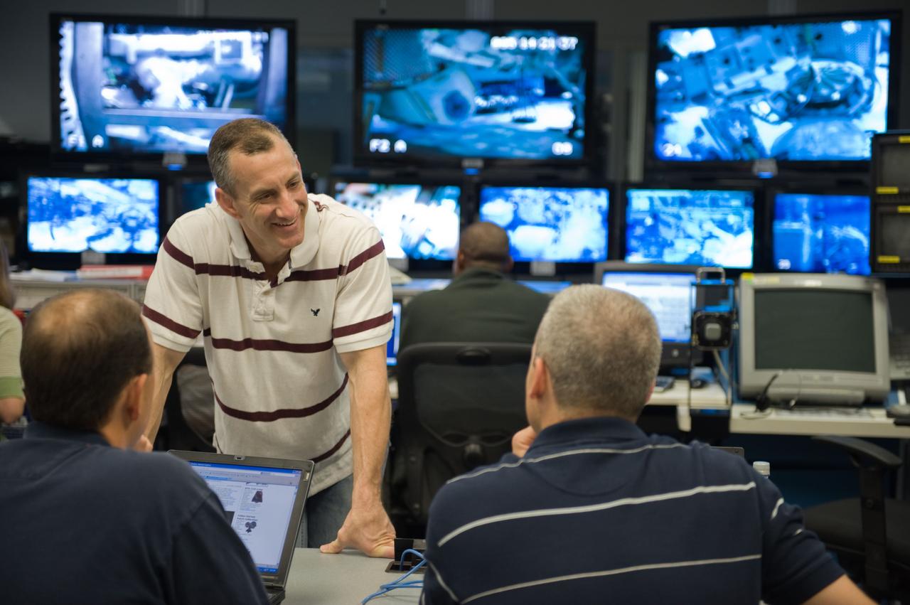 STS-129 crew members Mike Foreman, Randy Bresnik, Barry 'Butch' Wilmore and Robert Satcher prepare for 20A EVA Review dive at the NBL. Photo Date: March 26, 2009. Location - NBL Pool Topside and Control Room.  Photographer: Robert Markowitz