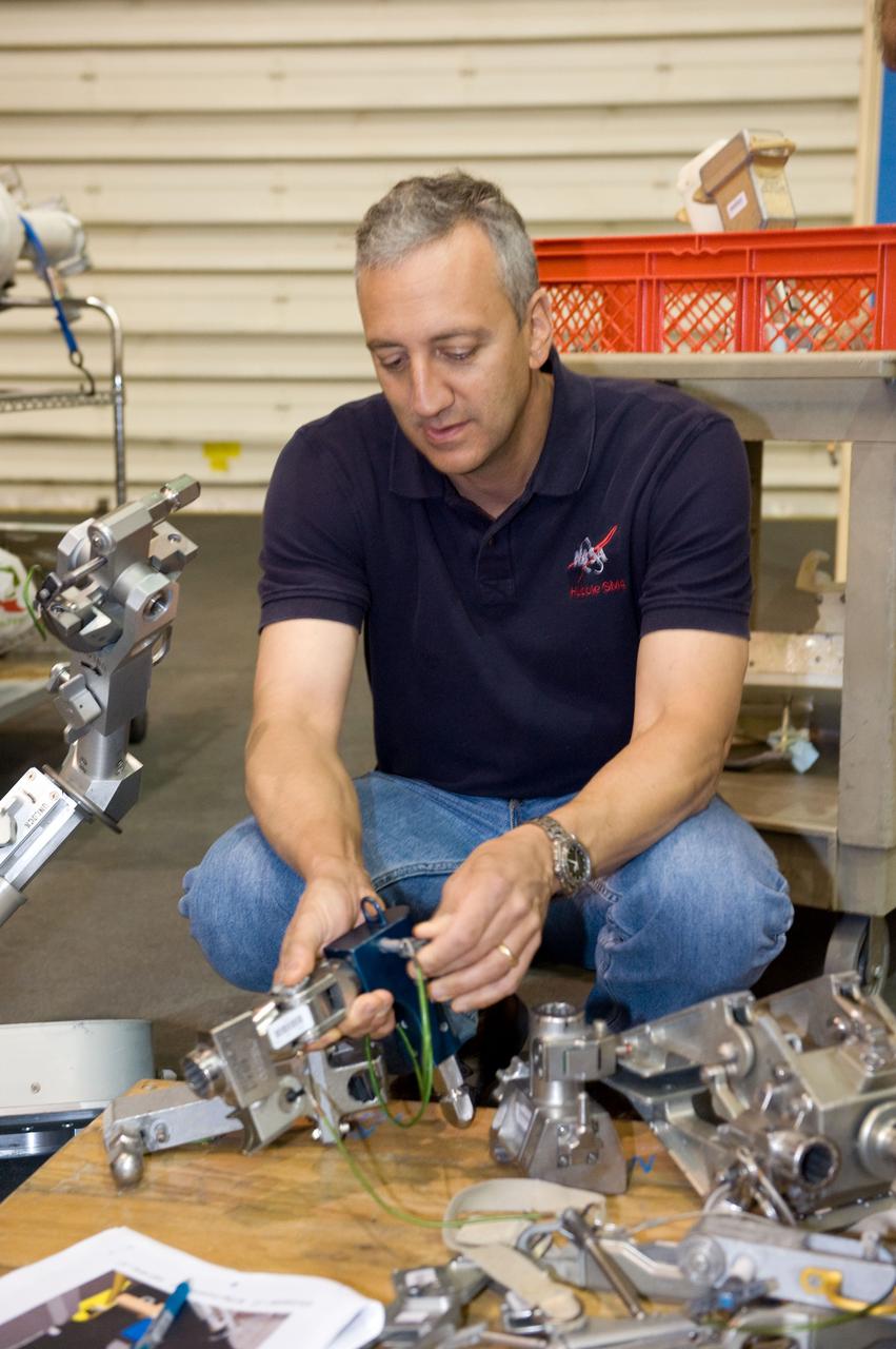 JSC2009-E-072668 (9 April 2009) --- Astronaut Mike Massimino, STS-125 mission specialist, works with extravehicular activity (EVA) hardware during a spacewalk training session in the Neutral Buoyancy Laboratory (NBL) near NASA's Johnson Space Center.