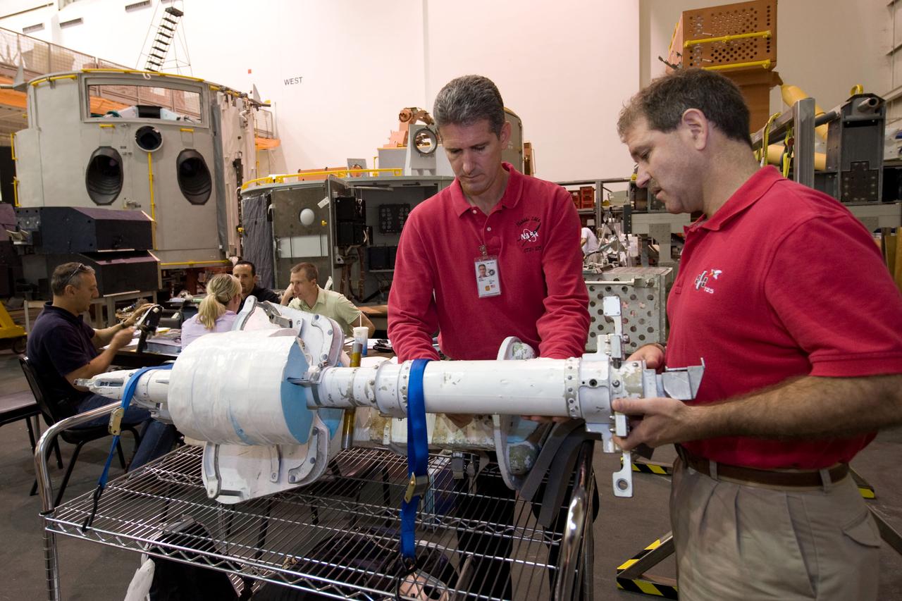JSC2009-E-072676 (9 April 2009) --- Astronauts Michael Good (left) and John Grunsfeld, both STS-125 mission specialists, participate in a spacewalk training session in the Neutral Buoyancy Laboratory (NBL) near NASA's Johnson Space Center.