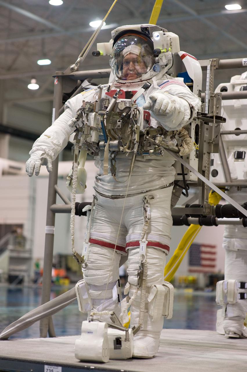 PHOTO DATE: 04-10-09 LOCATION: NBL - Pool Topside and Control Room SUBJECT: STS-129 crew members Michael Foreman and Robert Satcher during STS-129 ULF3 EVA 1 92027 training. Photograph preparations, getting in suit, working with suit techs, being lowered into water, other crew members in control room PHOTOGRAPHER: Devin Boldt