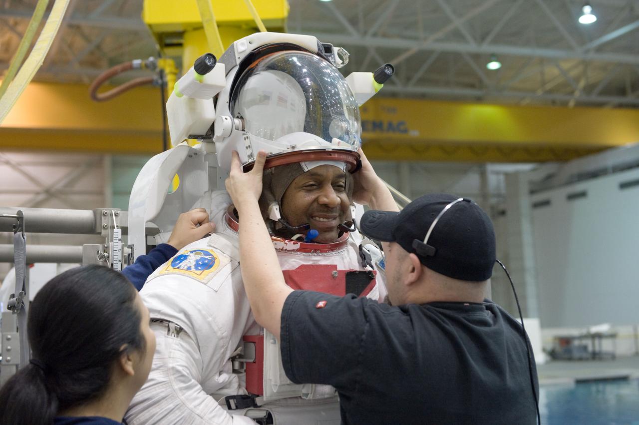 PHOTO DATE: 04-10-09 LOCATION: NBL - Pool Topside and Control Room SUBJECT: STS-129 crew members Michael Foreman and Robert Satcher during STS-129 ULF3 EVA 1 92027 training. Photograph preparations, getting in suit, working with suit techs, being lowered into water, other crew members in control room PHOTOGRAPHER: BILL STAFFORD