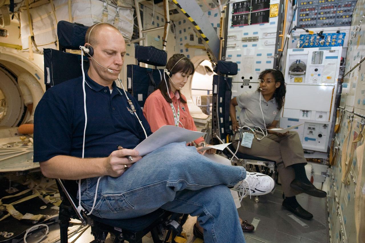 JSC2009-E-083987 (20 April 2009) --- Astronauts Clayton Anderson, Japan Aerospace Exploration Agency?s (JAXA) Naoko Yamazaki (center) and Stephanie Wilson, all STS-131 mission specialists, participate in a Full Fuselage Trainer (FFT) mock-up training session in the Space Vehicle Mock-up Facility at NASA's Johnson Space Center.