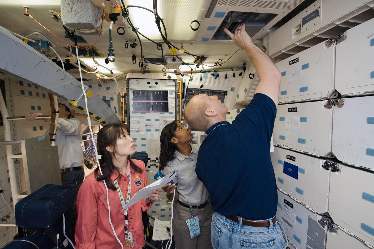 JSC2009-E-083988 (20 April 2009) --- Astronauts Clayton Anderson, Japan Aerospace Exploration Agency?s (JAXA) Naoko Yamazaki (left) and Stephanie Wilson, all STS-131 mission specialists, participate in a Full Fuselage Trainer (FFT) mock-up training session in the Space Vehicle Mock-up Facility at NASA's Johnson Space Center.