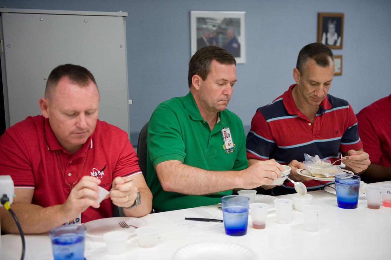 JSC2009-E-107049 (4 May 2009) --- Astronauts Charlie Hobaugh (right), STS-129 commander; Mike Foreman (center), mission specialist; and Barry Wilmore, pilot, participate in a food tasting session in the Habitability and Environmental Factors Office at NASA's Johnson Space Center.