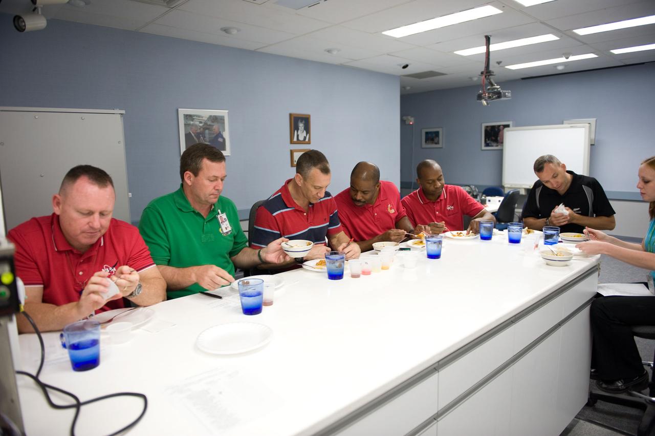 JSC2009-E-107053 (4 May 2009) --- STS-129 crewmembers participate in a food tasting session in the Habitability and Environmental Factors Office at NASA's Johnson Space Center. Pictured from the left are astronauts Barry Wilmore, pilot; Mike Foreman, mission specialist; Charlie Hobaugh, commander; Leland Melvin, Robert Satcher and Randy Bresnik, all mission specialists.