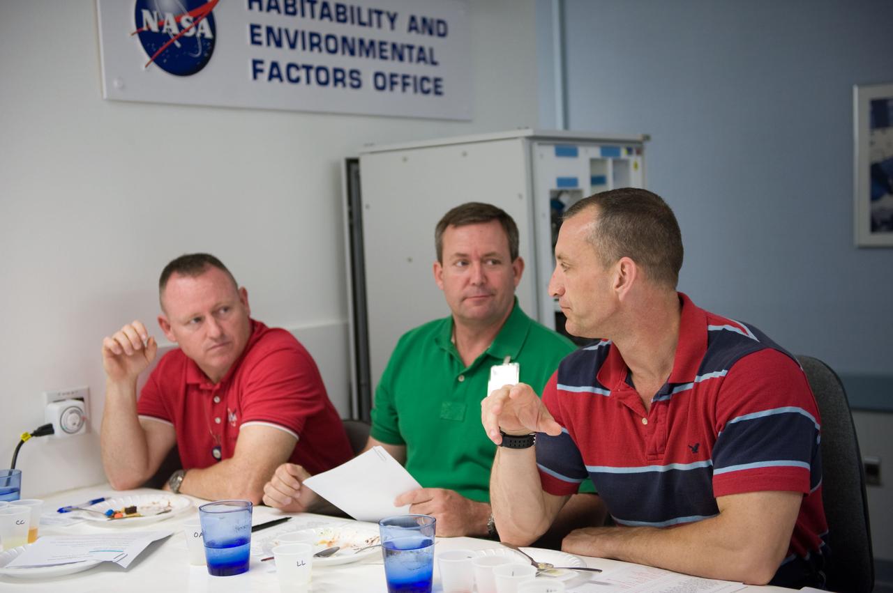 JSC2009-E-107057 (4 May 2009) --- Astronauts Charlie Hobaugh (right), STS-129 commander; Barry Wilmore (left), pilot; and Mike Foreman, mission specialist, participate in a food tasting session in the Habitability and Environmental Factors Office at NASA's Johnson Space Center.