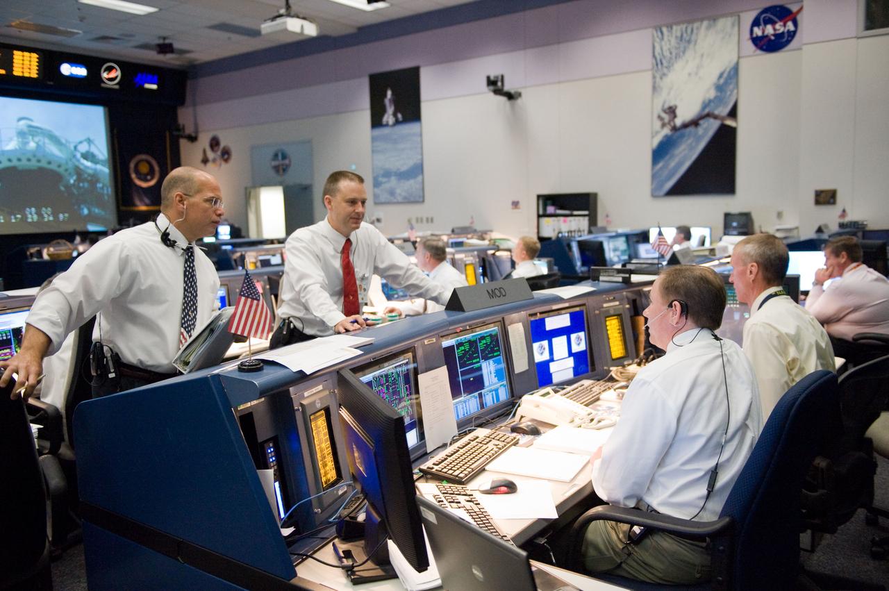 JSC2009-E-118819 (11 May 2009) --- John McCullough (seated foreground), chief of the flight director office; and Brent Jett (seated at right), director, flight crew operations; along with flight directors Tony Ceccacci (standing, left) and Norm Knight (standing, right), are pictured in the space shuttle flight control room in the Mission Control Center at NASA's Johnson Space Center during launch countdown activities a few hundred miles away in Florida, site of Space Shuttle Atlantis? scheduled STS-125 launch to service the Hubble Space Telescope. Liftoff was on time at 2:01 p.m. (EDT) on May 11, 2009 from launch pad 39A at NASA's Kennedy Space Center.