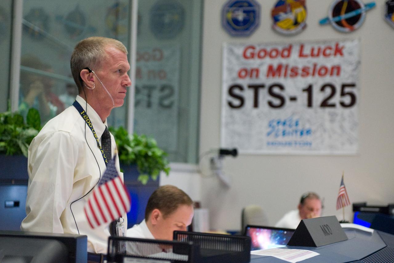 JSC2009-E-118821 (11 May 2009) --- Brent Jett (standing), director, flight crew operations; and John McCullough (seated), chief of the flight director office, are pictured in the space shuttle flight control room in the Mission Control Center at NASA's Johnson Space Center during launch countdown activities a few hundred miles away in Florida, site of Space Shuttle Atlantis? scheduled STS-125 launch to service the Hubble Space Telescope. Liftoff was on time at 2:01 p.m. (EDT) on May 11, 2009 from launch pad 39A at NASA's Kennedy Space Center.