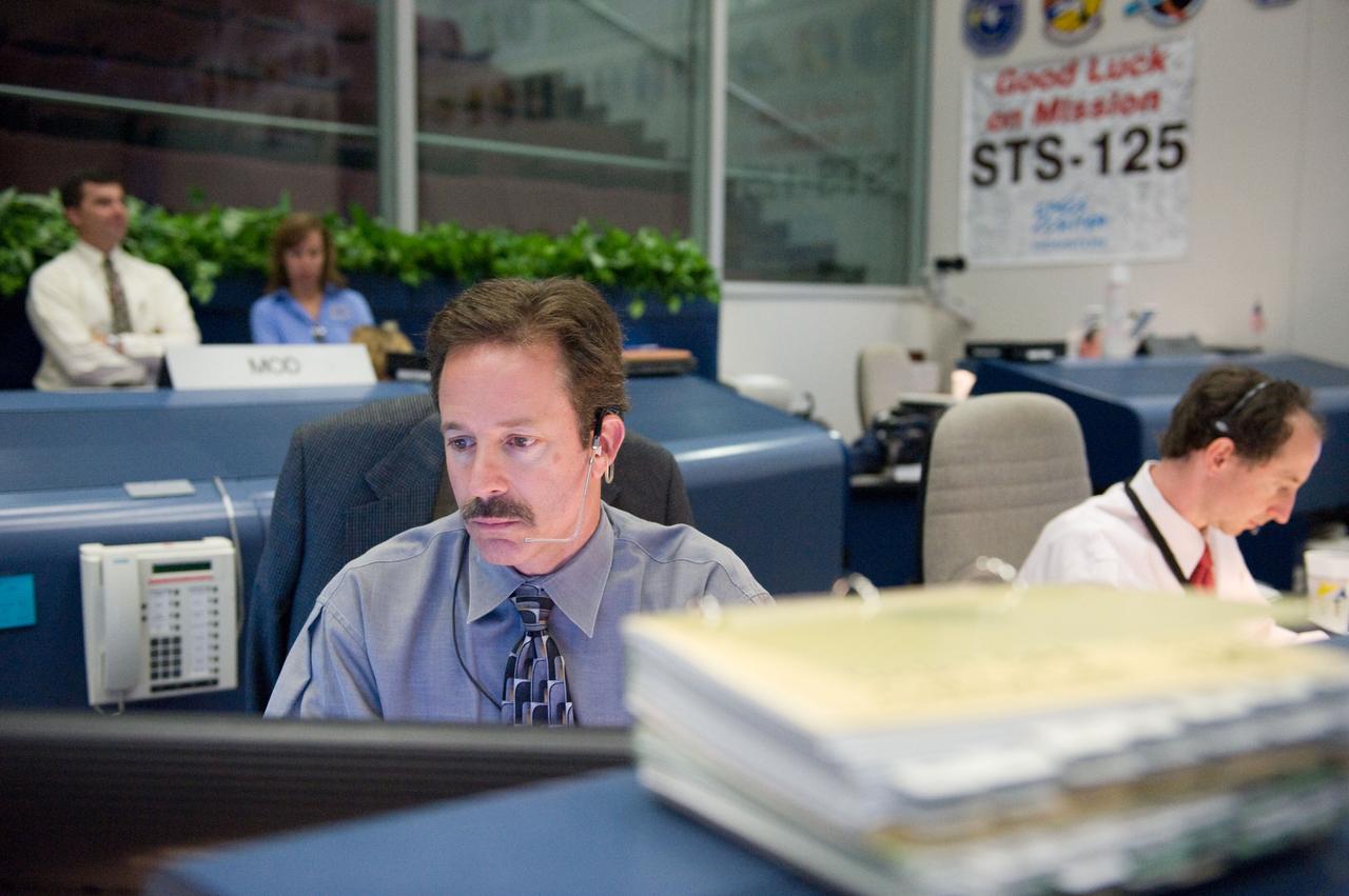 JSC2009-E-119382 (12 May 2009) --- Flight director Rick LaBrode monitors data at his console in the space shuttle flight control room in the Mission Control Center at NASA's Johnson Space Center during STS-125 flight day two activities. Flight director Chris Edelen is at right.