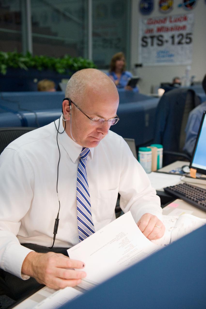 JSC2009-E-119391 (12 May 2009) --- Astronaut Alan Poindexter, STS-125 spacecraft communicator (CAPCOM), monitors data at his console in the space shuttle flight control room in the Mission Control Center at NASA's Johnson Space Center during flight day two activities.