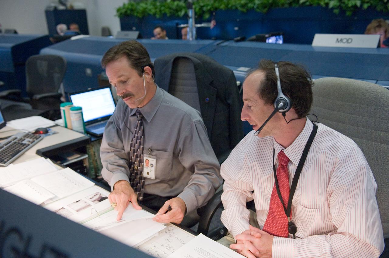 JSC2009-E-119397 (12 May 2009) --- Flight directors Rick LaBrode (left) and Chris Edelen monitor data at their console in the space shuttle flight control room in the Mission Control Center at NASA's Johnson Space Center during STS-125 flight day two activities.