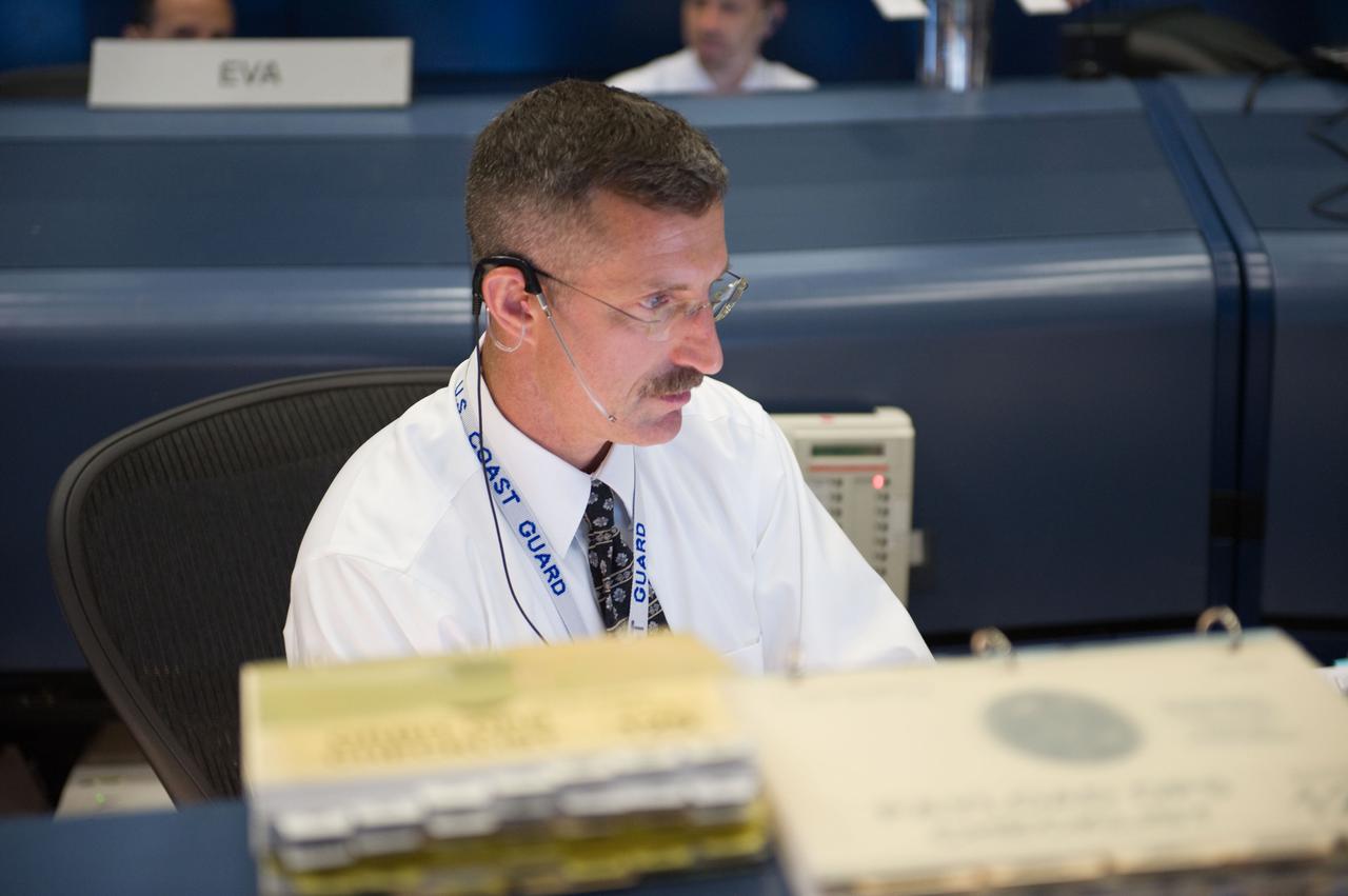JSC2009-E-119633 (13 May 2009) --- Astronaut Dan Burbank, STS-125 spacecraft communicator (CAPCOM), monitors data at his console in the space shuttle flight control room in the Mission Control Center at NASA's Johnson Space Center during flight day three activities.