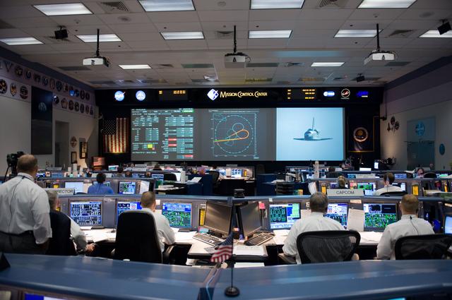 NASA image: STS-125 Entry flight controllers on console with Flight Director Norman Knight 