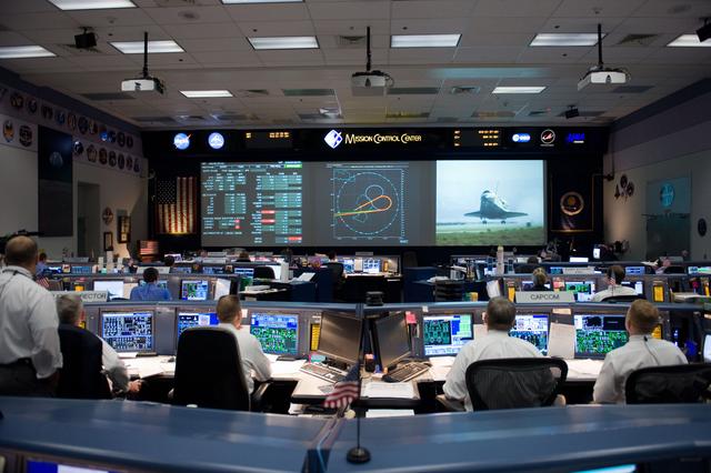 NASA image: STS-125 Entry flight controllers on console with Flight Director Norman Knight 