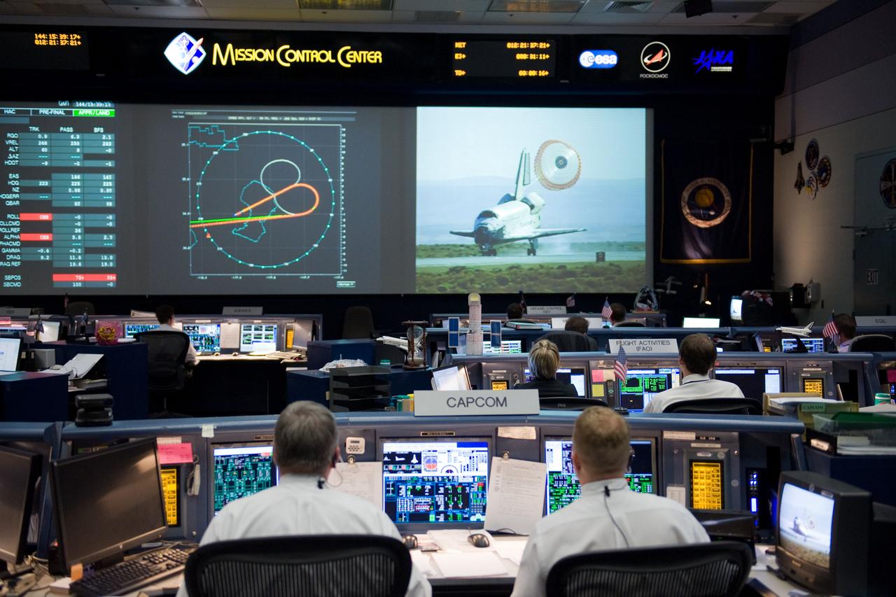 JSC2009-E-121512 (24 May 2009) --- Flight controllers in the space shuttle flight control room in the Mission Control Center at NASA's Johnson Space Center watch the big screens during the landing of Space Shuttle Atlantis (STS-125) at Edwards Air Force Base in California.