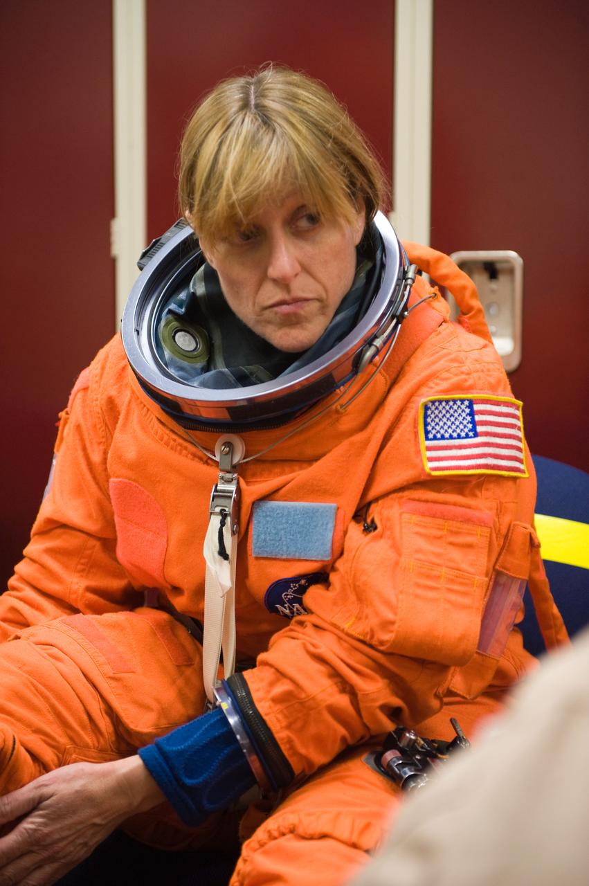 JSC2009-E-125130 (1 June 2009) --- Astronaut Kathryn Hire, STS-130 mission specialist, dons a training version of her shuttle launch and entry suit in preparation for a training session in the Space Vehicle Mock-up Facility at NASA?s Johnson Space Center.